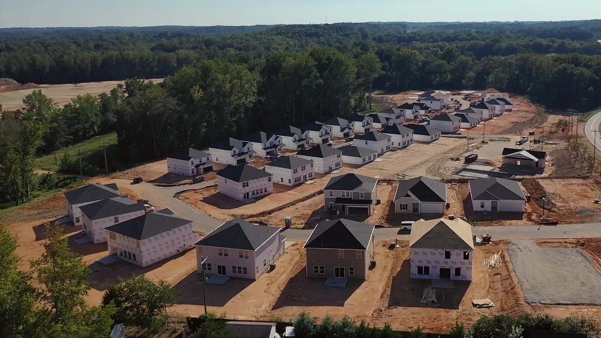 Aerial view of a community of new homes going up on cleared lots